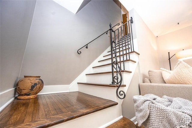 stairway featuring vaulted ceiling