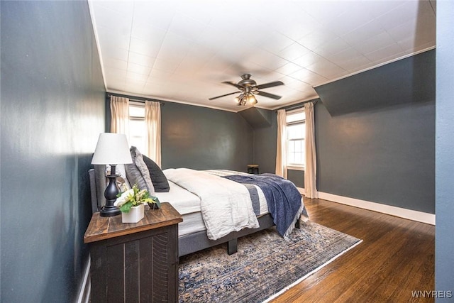 bedroom featuring wood finished floors, a ceiling fan, and baseboards