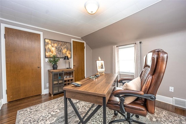 office area with baseboards, visible vents, vaulted ceiling, and wood finished floors