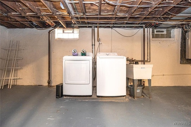 below grade area with washing machine and dryer and electric panel