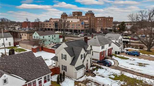 snowy aerial view with a residential view and a city view