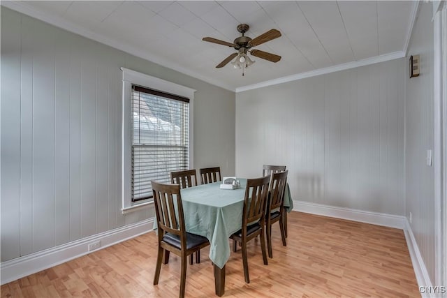 dining area featuring a ceiling fan, light wood-type flooring, ornamental molding, and baseboards