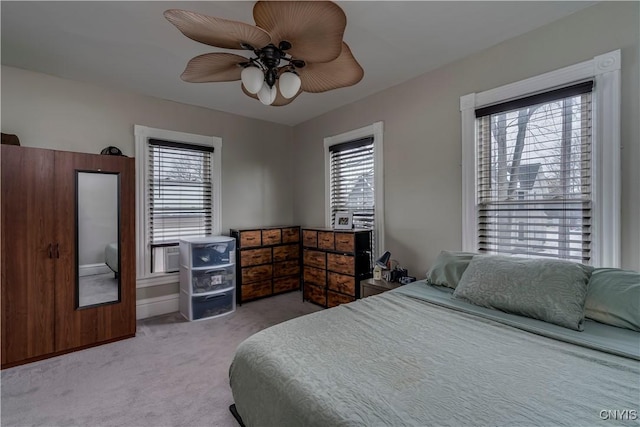 bedroom with ceiling fan and light colored carpet