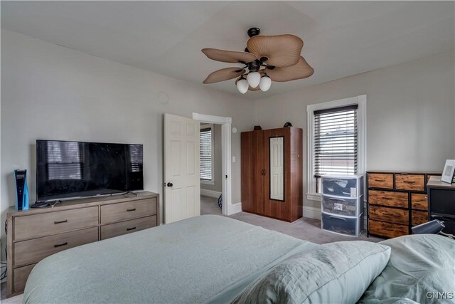 bedroom with a ceiling fan, carpet flooring, and baseboards