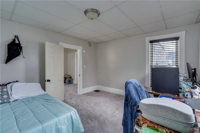 bedroom featuring a paneled ceiling, carpet, and baseboards