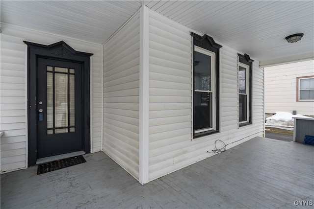 view of exterior entry with covered porch