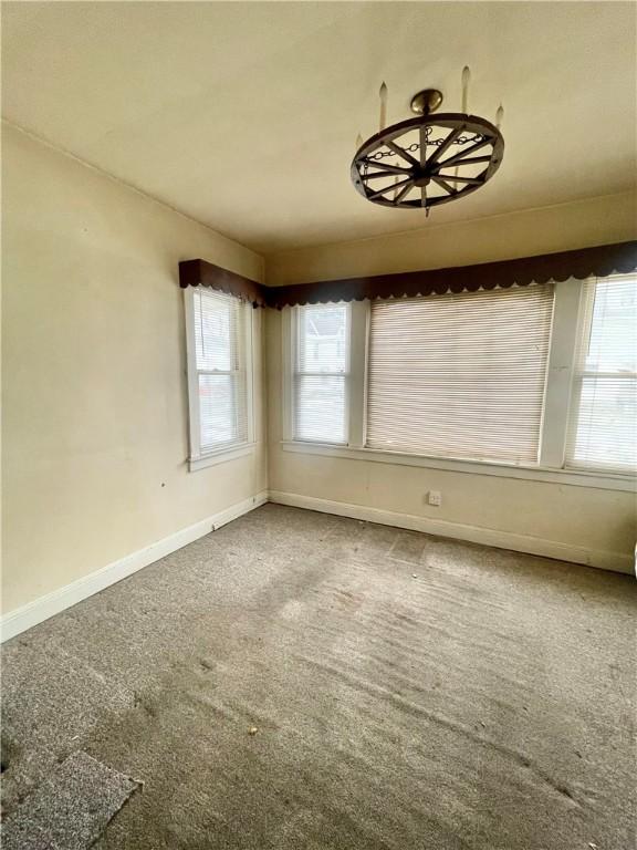 spare room with carpet flooring and baseboards