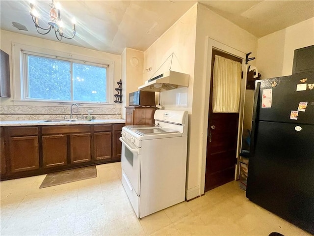 kitchen with black appliances, under cabinet range hood, light countertops, and a sink