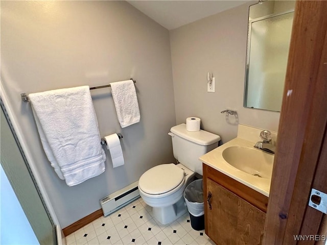 bathroom with toilet, baseboard heating, a stall shower, vanity, and baseboards