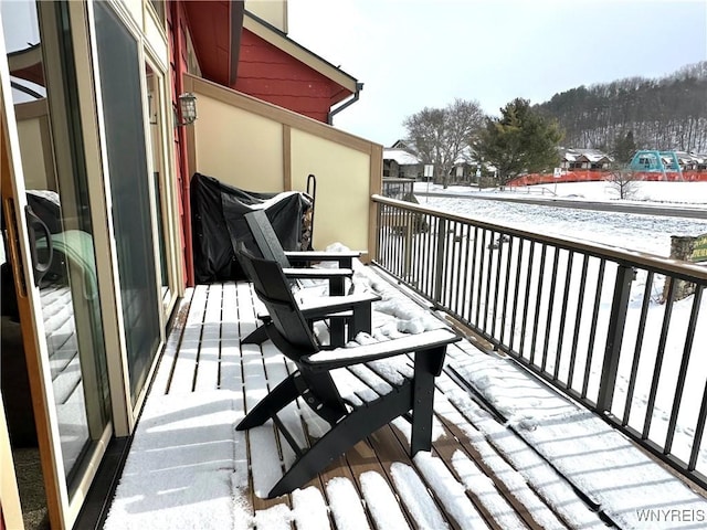 view of snow covered back of property