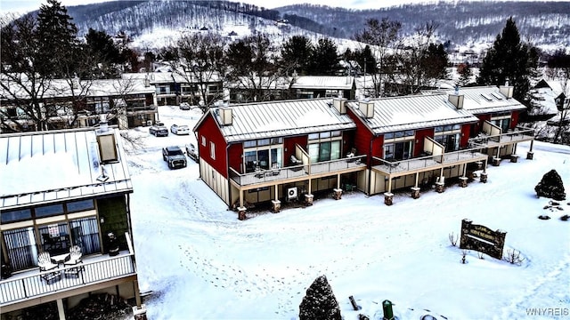 snowy aerial view featuring a mountain view