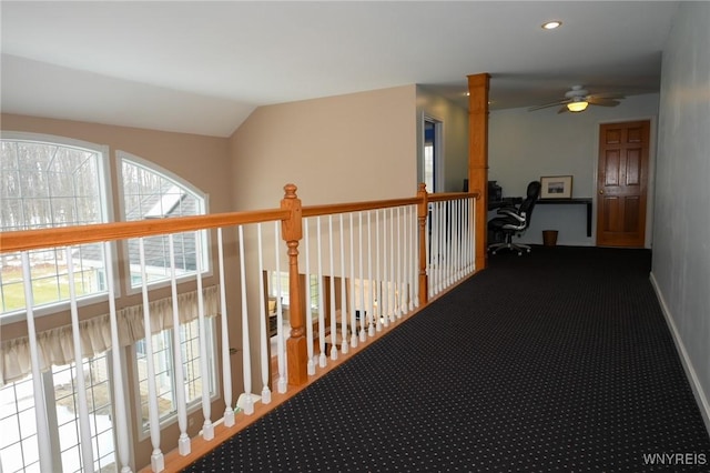 hallway featuring lofted ceiling, baseboards, carpet, and recessed lighting