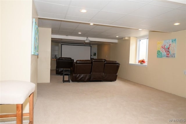 carpeted cinema room with a paneled ceiling and recessed lighting