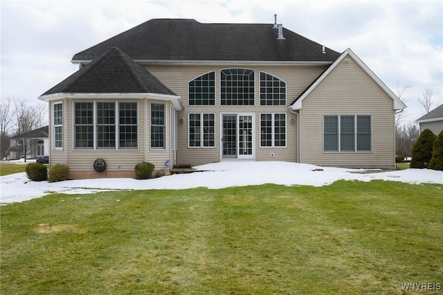 back of house with a patio area, a lawn, and roof with shingles