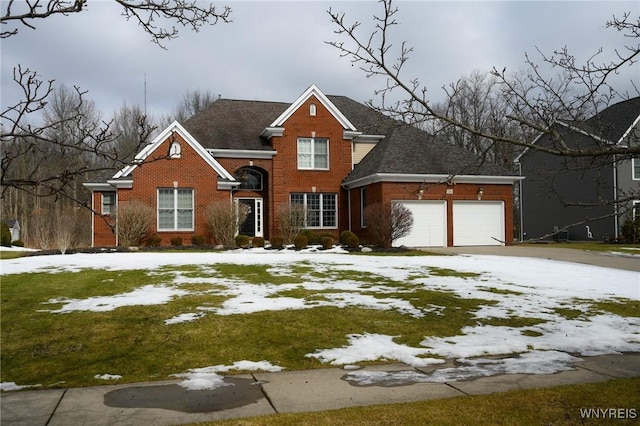 traditional home with an attached garage, driveway, and brick siding