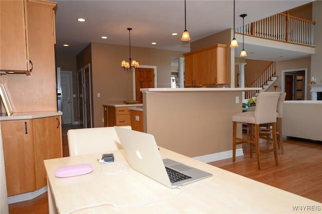 dining room featuring stairway, recessed lighting, light wood-style flooring, and an inviting chandelier