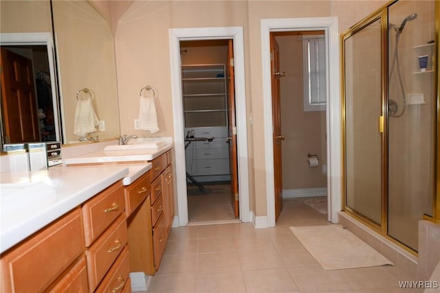 full bath featuring a walk in closet, tile patterned flooring, and a shower stall