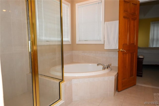 full bathroom with a stall shower, tile patterned flooring, and a bath