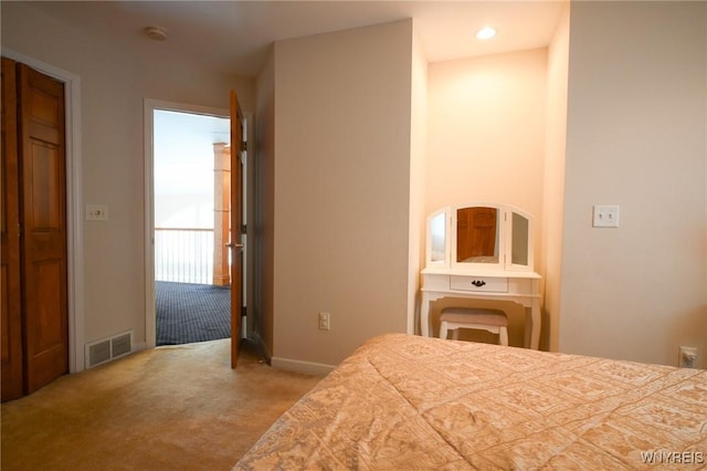 bedroom with carpet floors, baseboards, and visible vents