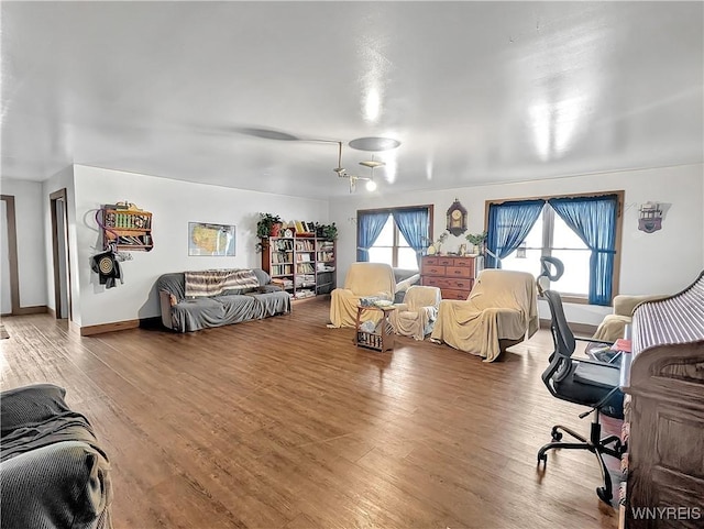 bedroom with baseboards and wood finished floors