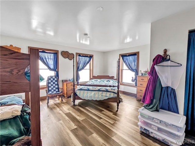 bedroom with baseboards and wood finished floors