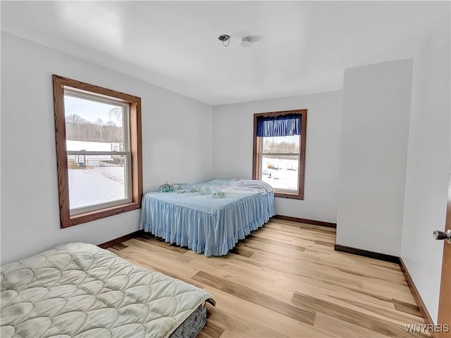 bedroom featuring baseboards and light wood-style floors