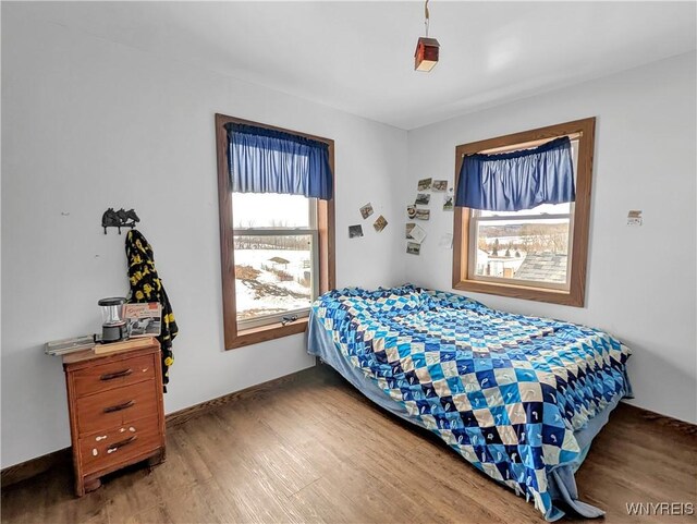 bedroom with light wood-style floors and baseboards