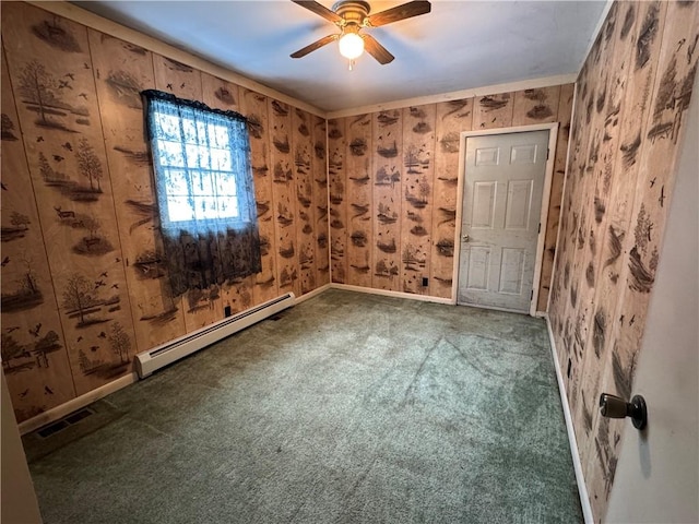 spare room with visible vents, baseboards, a baseboard radiator, ceiling fan, and carpet