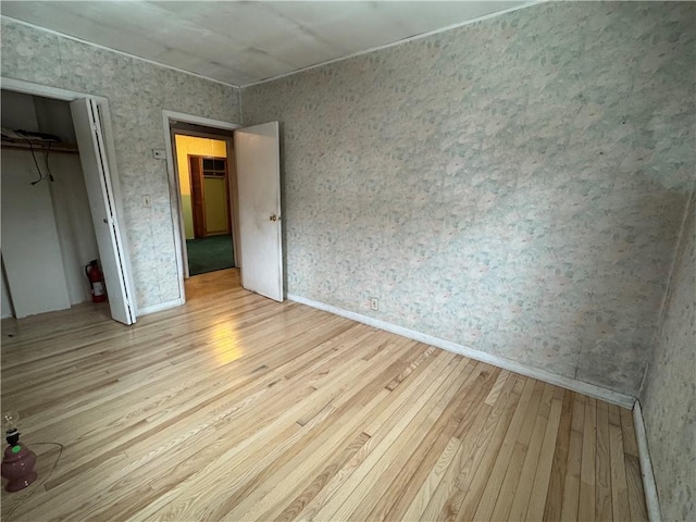 unfurnished bedroom featuring a closet and hardwood / wood-style floors