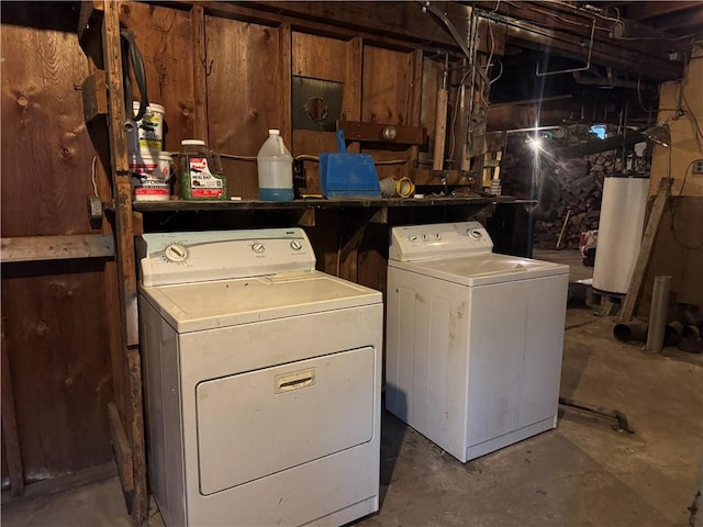 washroom with laundry area, gas water heater, and washer and dryer