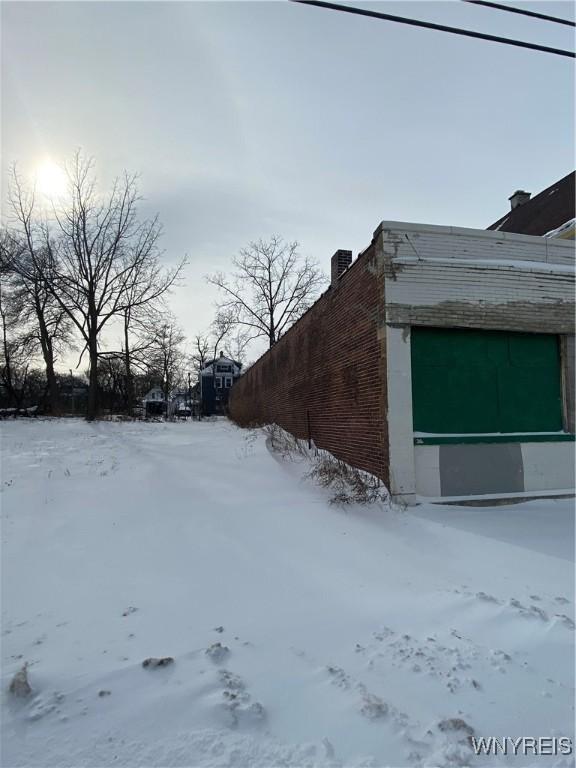 yard layered in snow with a garage