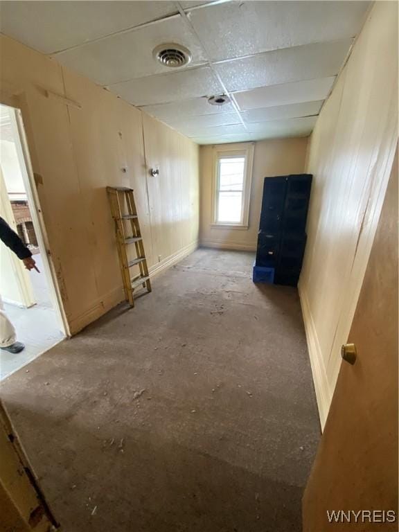 empty room with a paneled ceiling and visible vents