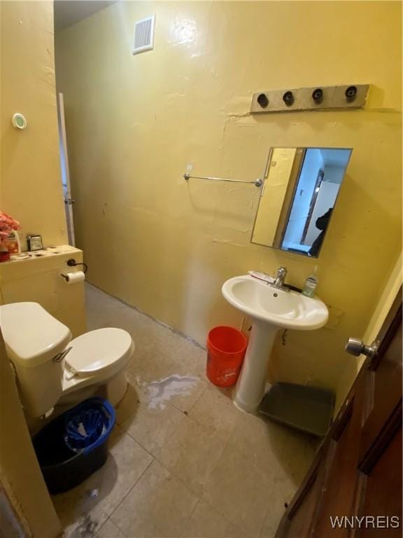 bathroom with visible vents, a sink, and toilet