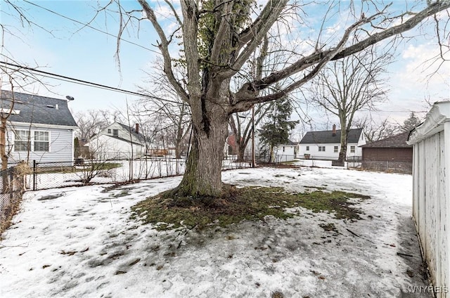 yard covered in snow with fence