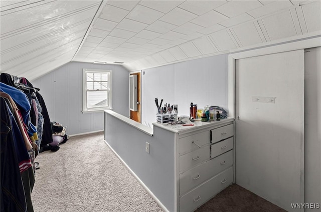 spacious closet with lofted ceiling and dark carpet