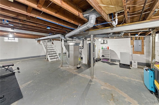 below grade area with heating unit, stairs, electric panel, and gas water heater