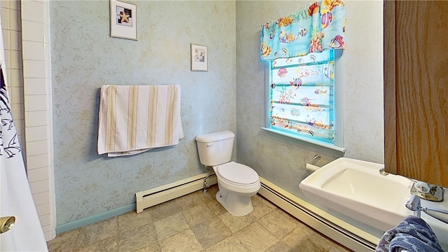 bathroom featuring a shower with shower curtain, baseboards, toilet, and baseboard heating