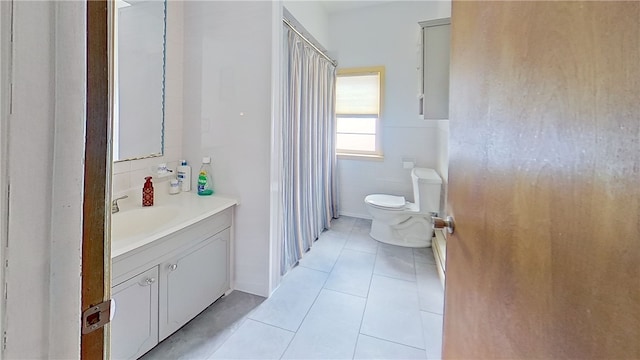 bathroom with tile patterned flooring, a shower with curtain, vanity, and toilet