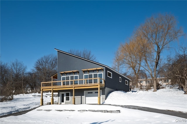 view of front of home featuring a deck and an attached garage