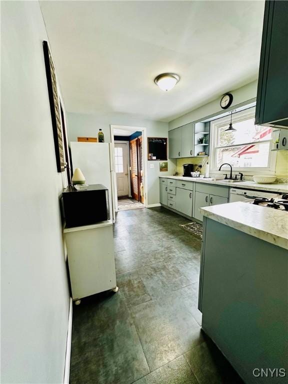 kitchen featuring light countertops, green cabinetry, plenty of natural light, and open shelves