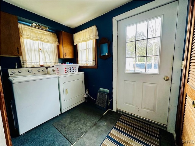 washroom featuring a healthy amount of sunlight, cabinet space, and separate washer and dryer