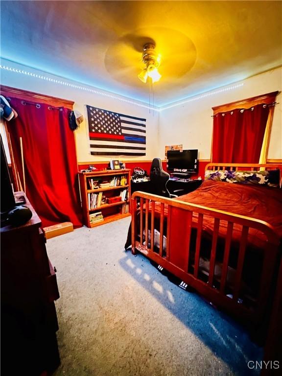 bedroom with carpet floors and a ceiling fan