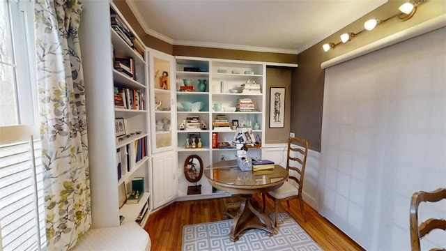 interior space with ornamental molding and wood finished floors