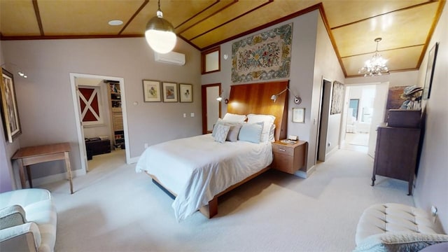 bedroom with light carpet, ensuite bathroom, a notable chandelier, and a wall mounted air conditioner