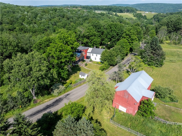 bird's eye view with a wooded view