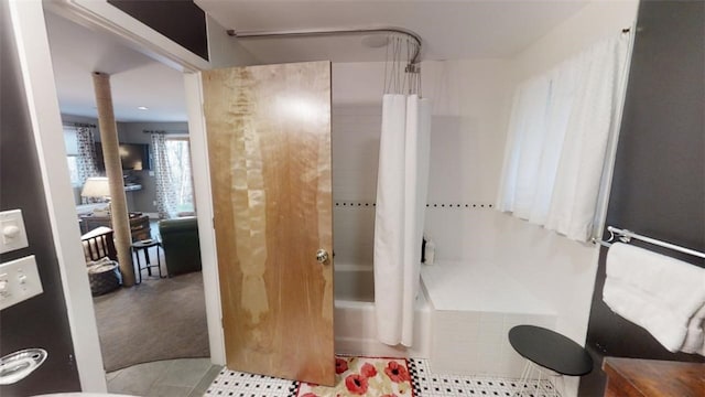 full bathroom with decorative columns, shower / bath combo with shower curtain, and tile patterned floors