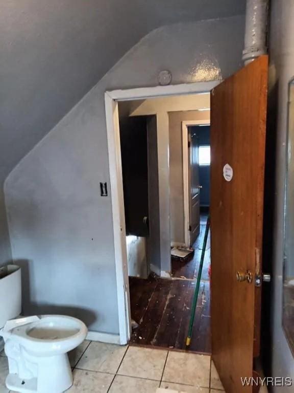 bathroom featuring lofted ceiling, toilet, and tile patterned floors