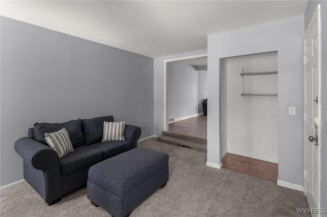 living area with baseboards and carpet flooring