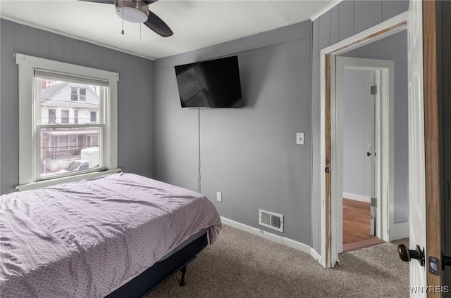 bedroom featuring carpet floors, a ceiling fan, visible vents, and baseboards