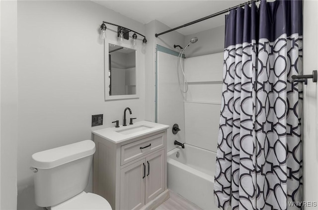 bathroom featuring vanity, toilet, and shower / bath combo with shower curtain